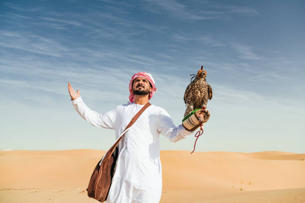 istock arab man with falcon in the desert 2187865488