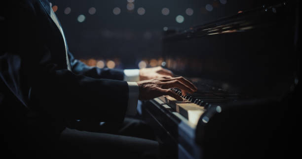 Close Up on Pianist Hands Playing a Mesmerizing Jazz Melody on a Black Grand Piano. Anonymous Artist is Focused on Creating Beautiful Instrumental Sonata as He Plays on Stage for the Audience