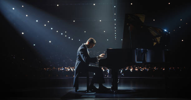 istock Young Pianist Playing Academic Music, Performing Classical Solo Compositions on Stage. Grand Piano Resounds With Rich, Melodic Tones of a Romantic Ballad, Pianist Filling Each Chord with Nostalgia 2187865812