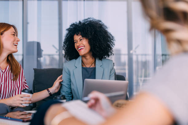 istock Happy Businesswomen Sharing a Moment in a Modern Office Setting 2187866176