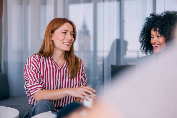 istock Women Engaging in Friendly Conversation During Meeting Break 2187866178