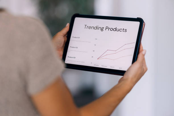 istock Close-Up of Person Analyzing Trending Products on Tablet Screen 2187866184