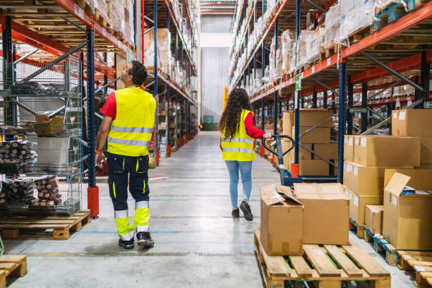 istock Warehouse workers managing logistics and inventory using pallet jack and checking stock 2187866214
