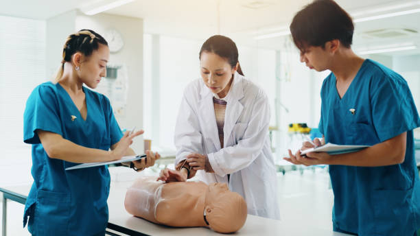 Mannequin, students and cpr training in hospital for medical simulation exam, test or project. Healthcare, professor and group with rescue support demonstration on patient dummy at college