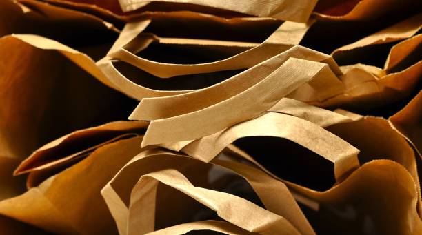 istock Paper patterns. Paper bags in black background. Artistic wallpaper 2187871580