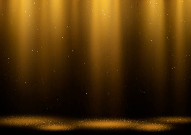 Golden sparkling light curtain Twinkling gold glitter falling on the stage illuminated with many spot lights. gold layer stock pictures, royalty-free photos & images