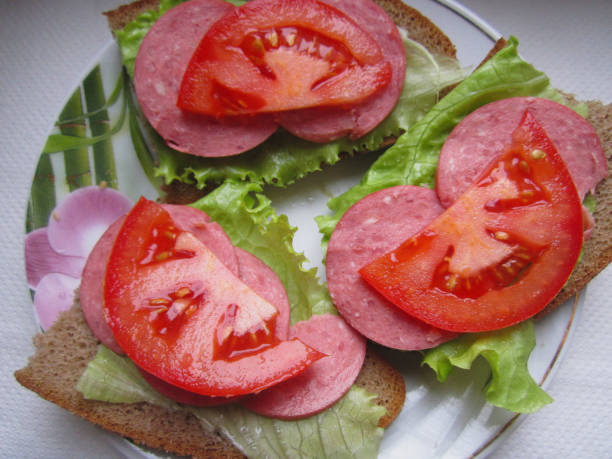 Sandwiches with sausage and lettuce.