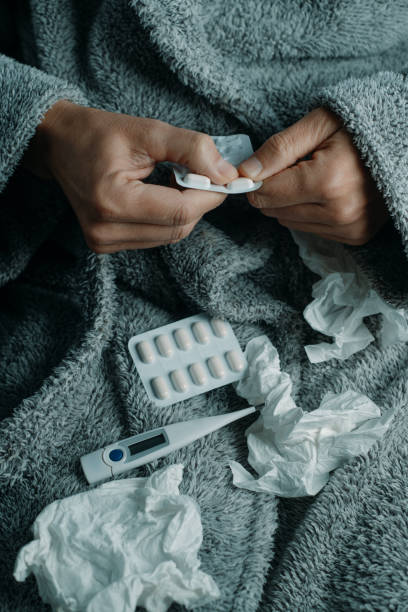 istock ill man at home is about to take a pill 2187875563