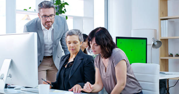 istock Coaching, computer and management with business people in office together for collaboration or training. Coaching, feedback and learning with corporate employee group in workplace for development 2187875958