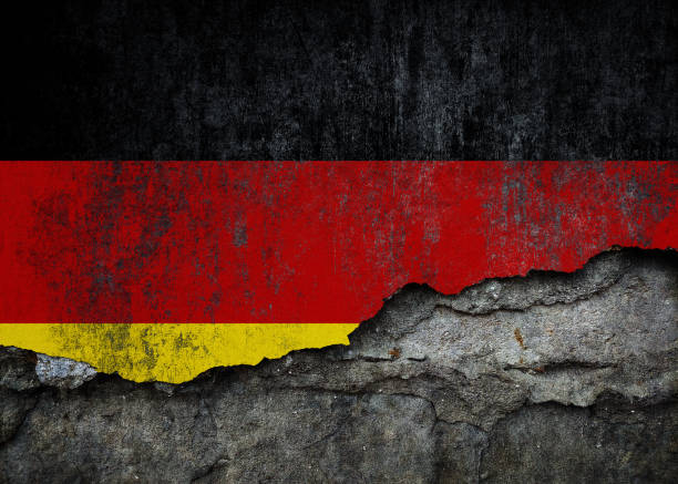 istock German Flag in Grunge Style, Damaged Paint on Rough Wall Background 2187876046