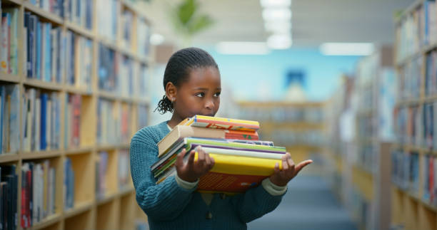 Books, search or African child in library for knowledge, development and learning growth. Female kid, looking or curious scholarship student in primary school for studying or education