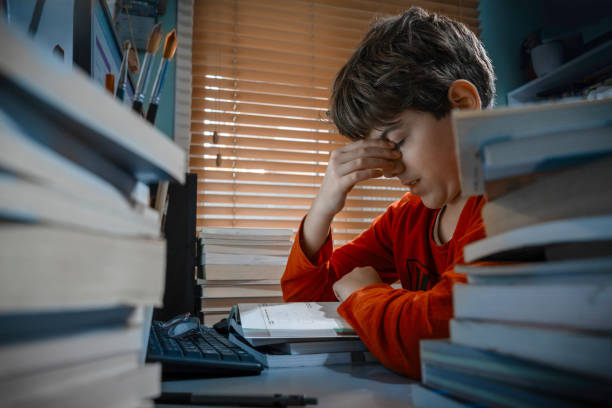 Tired student struggling with homework at home