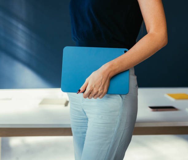 istock Person Holding Blue Tablet in Bright Modern Office Environment 2187877848
