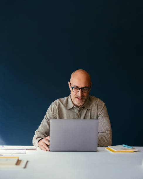 istock Mature Man Working on Laptop in Office Setting 2187877898
