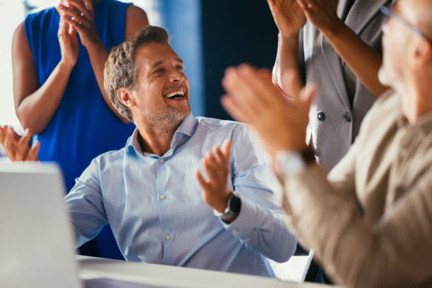 Business Team Celebrating Success With Enthusiastic Applause