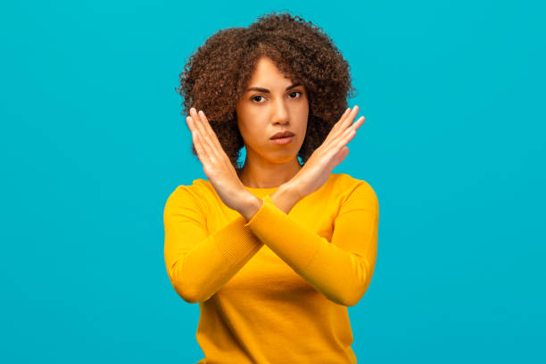 istock Woman Making X Gesture Against Blue Background 2187878939