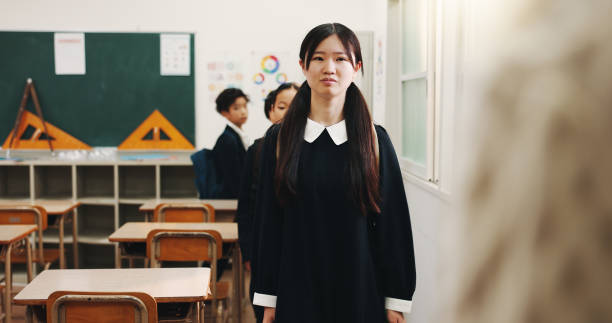 istock Education, student and child in classroom, anxious and nervous for presentation assignment and learning. High school, shy and girl with stage fright, knowledge or teenager with social phobia in Japan 2187885955
