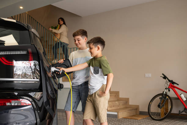 istock Family charging electric car at home. 2187887563
