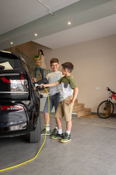 istock Family charging electric car at home. 2187887577