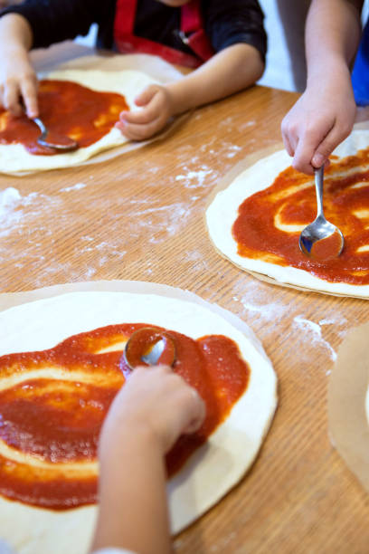 istock Children participate cooking master class. Culinary courses for children. Cooking pizza. 2187889093