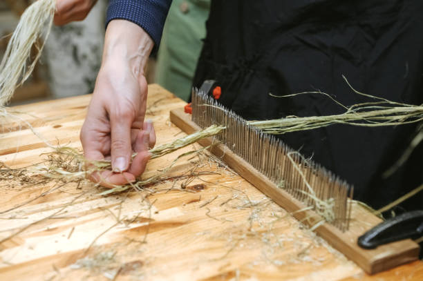 istock Traditional craftsmanship in action: hand processing hemp fiber for sustainable textiles 2187889639