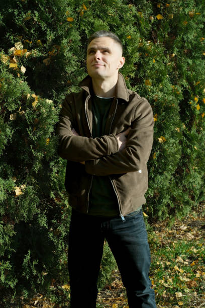 istock Enthusiastic man posing confidently in a vibrant garden setting 2187889850