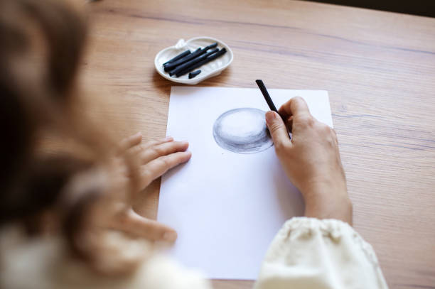 istock Artist Sketching Sphere with Charcoal on Paper 2187893994