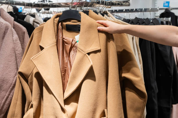 istock Customer Hand Picking Coat from Clothing Rack in Store 2187894058