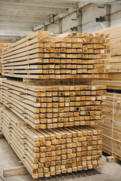 istock Stacks of square timber planks forming geometric pattern in lumber warehouse 2187897680
