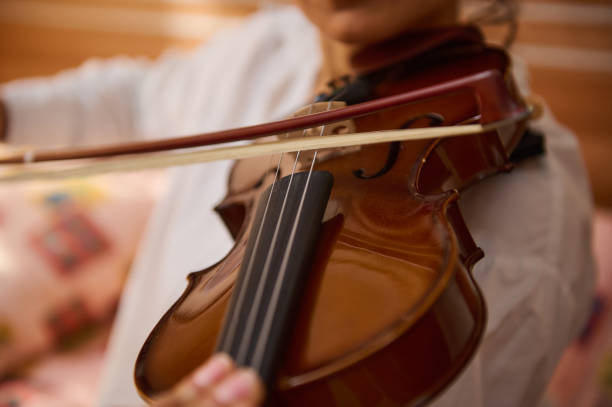 istock Close-up of musician playing a violin with focus on strings and bow 2187897993