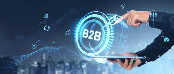 istock Businessman using tablet with B2B concept, network icons, and cityscape in background. 2187903595