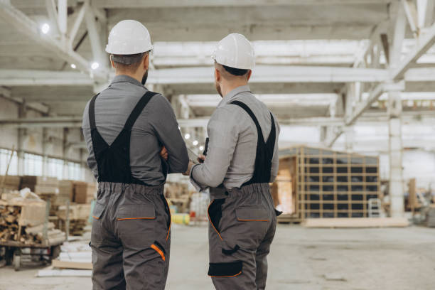 istock Engineers discussing prefabricated modular building in large warehouse 2187903782