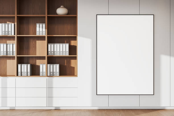 istock Modern office interior with wooden shelves and blank poster on wall. 3D Rendering 2187903797