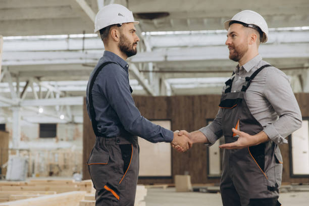 istock Construction workers shaking hands in modular building factory 2187903854