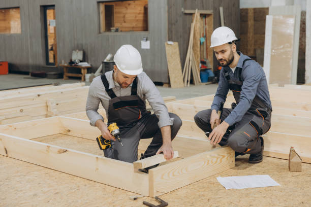 istock Carpenters building wooden frame for modular house in workshop 2187903969
