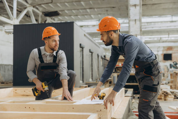 istock Builders working on wooden frame for modular building 2187904078