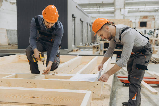 istock Construction workers building wooden frame in factory for modular building industry 2187904127