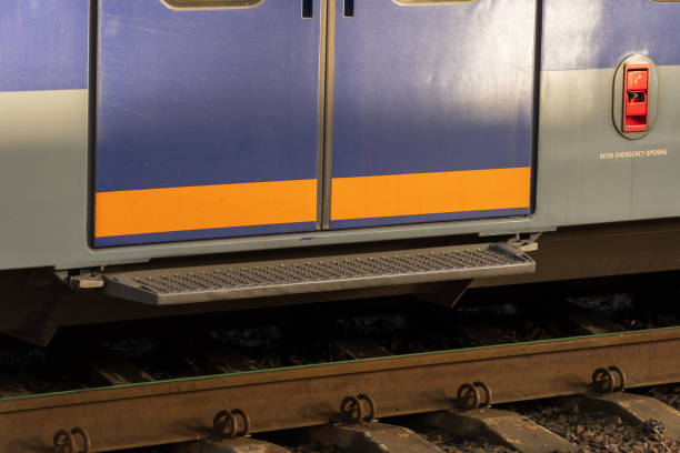 istock A modern electric train stands at a railway platform, showcasing its closed doors. Nearby, the tracks undergo maintenance during the late afternoon, highlighting industrial efficiency 2187904822