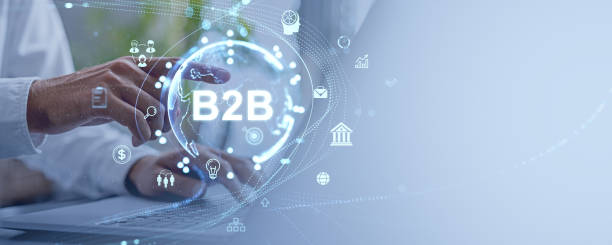 istock Business person's hand pointing at a B2B holographic interface with various icons over a light blue background. 2187904878