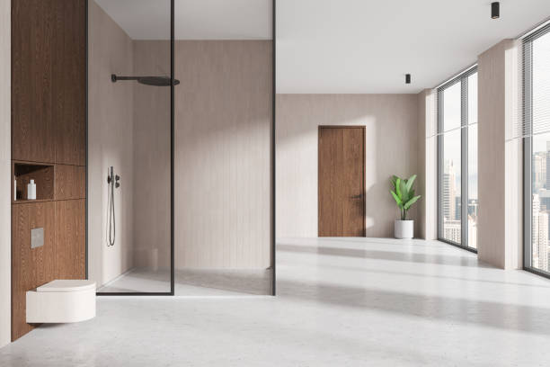 istock Light home bathroom interior with glass shower, toilet and panoramic window 2187904903