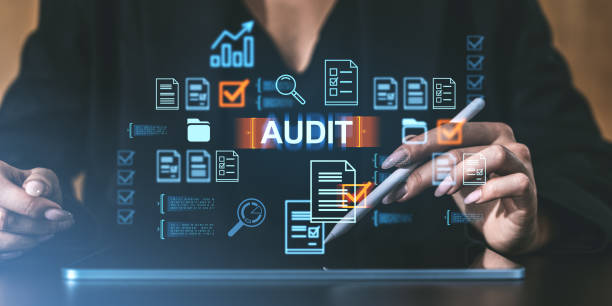 istock Digital audit concept with floating icons, hands using a tablet. Futuristic style on dark background. Concept of data analysis 2187905463