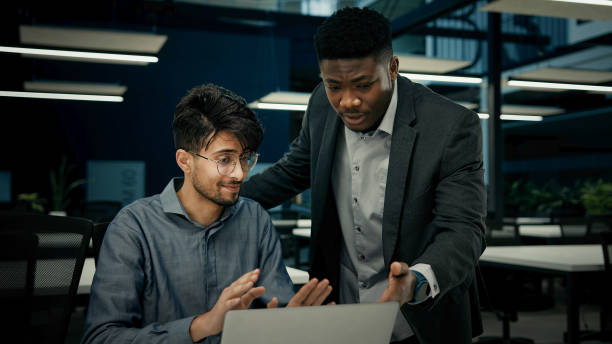 istock Male businessmen colleagues work with computer corporate teamwork develop digital business presentation two multiracial men arabian guy and african man discussing project software co-working at office 2187910167