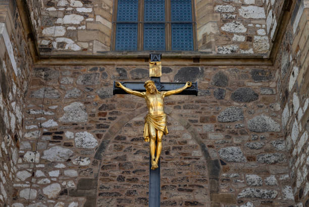 A picture of a golden Jesus statue outside of the Cathedral of Saint Peter and Paul, Brno.