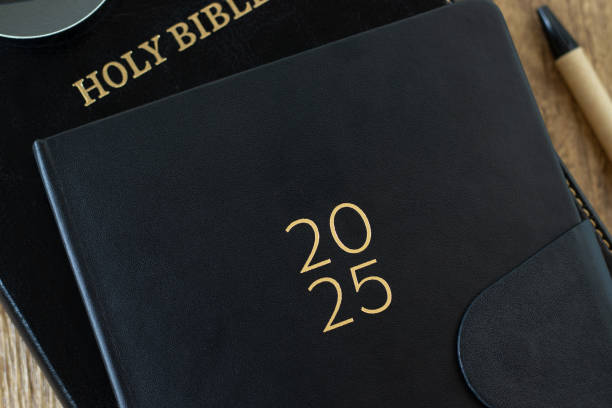 istock 2025 Calendar notebook with holy bible book, top ciew 2187911663