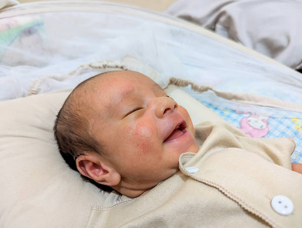 istock Close up Newborn baby boy in bed, sleeping under white soft blanket with animal pattern 2187914761