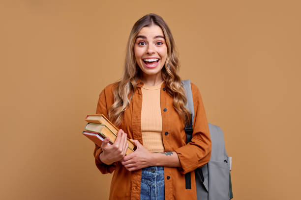 istock A Cheerful Student Carrying Books While Dressed in Casual Attire and Enjoying Life 2187915123