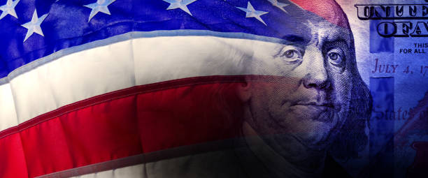 istock American flag and American one hundred dollar bill 2187915268