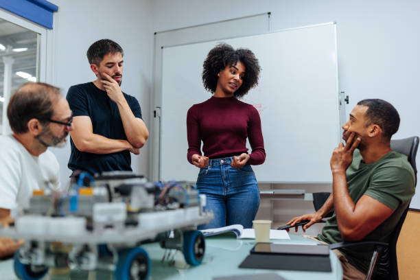 istock Engineers discussing a robotics project in meeting room 2187916943