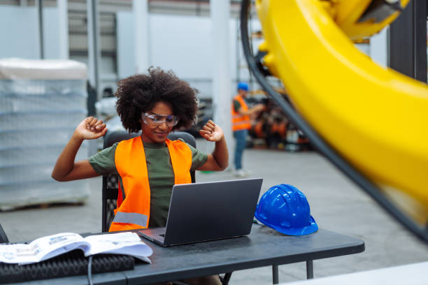 istock Female engineer stretching arms while working on laptop in factory 2187918332