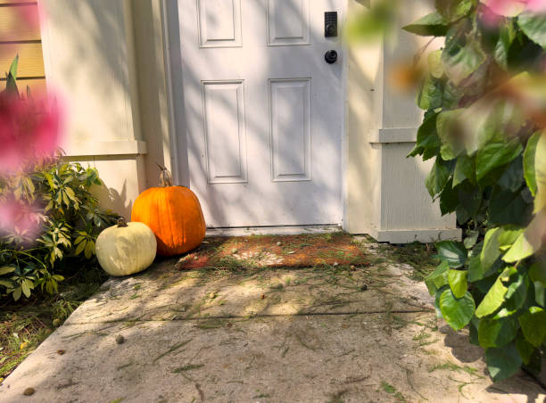 istock Front door with pumpkins autumn decoration for halloween 2187919221